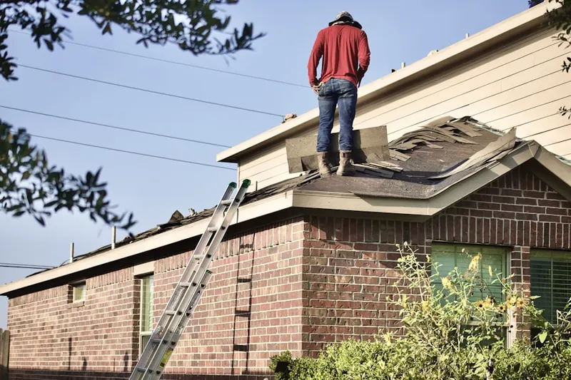 Professional roofer working on a residential roof in North Mianus